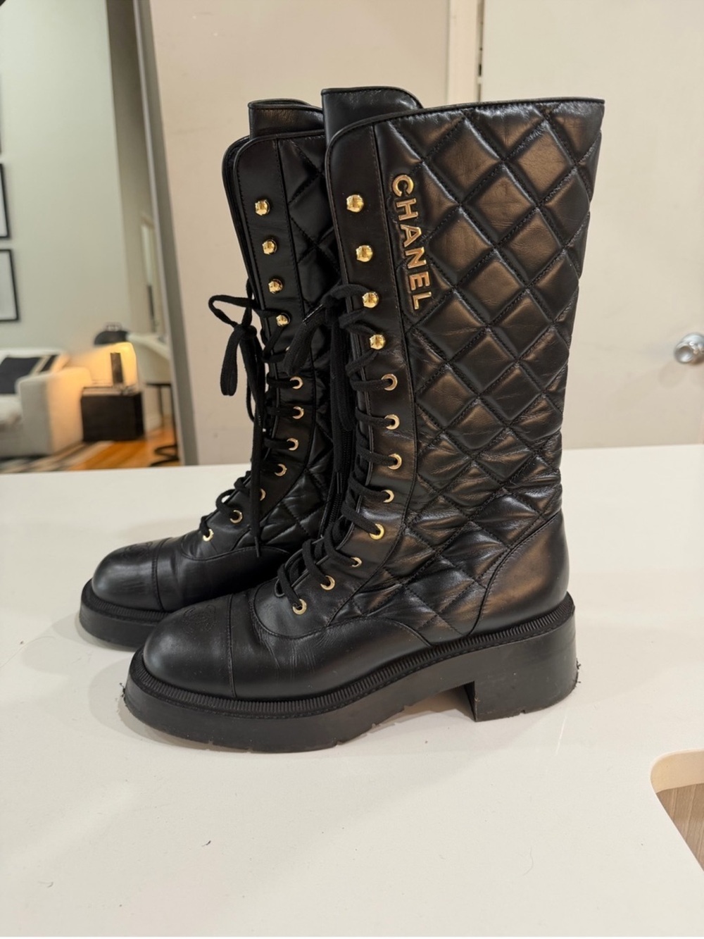 CHANEL Black Quilted Leather Lace-Up Knee Boots with Gold Logo